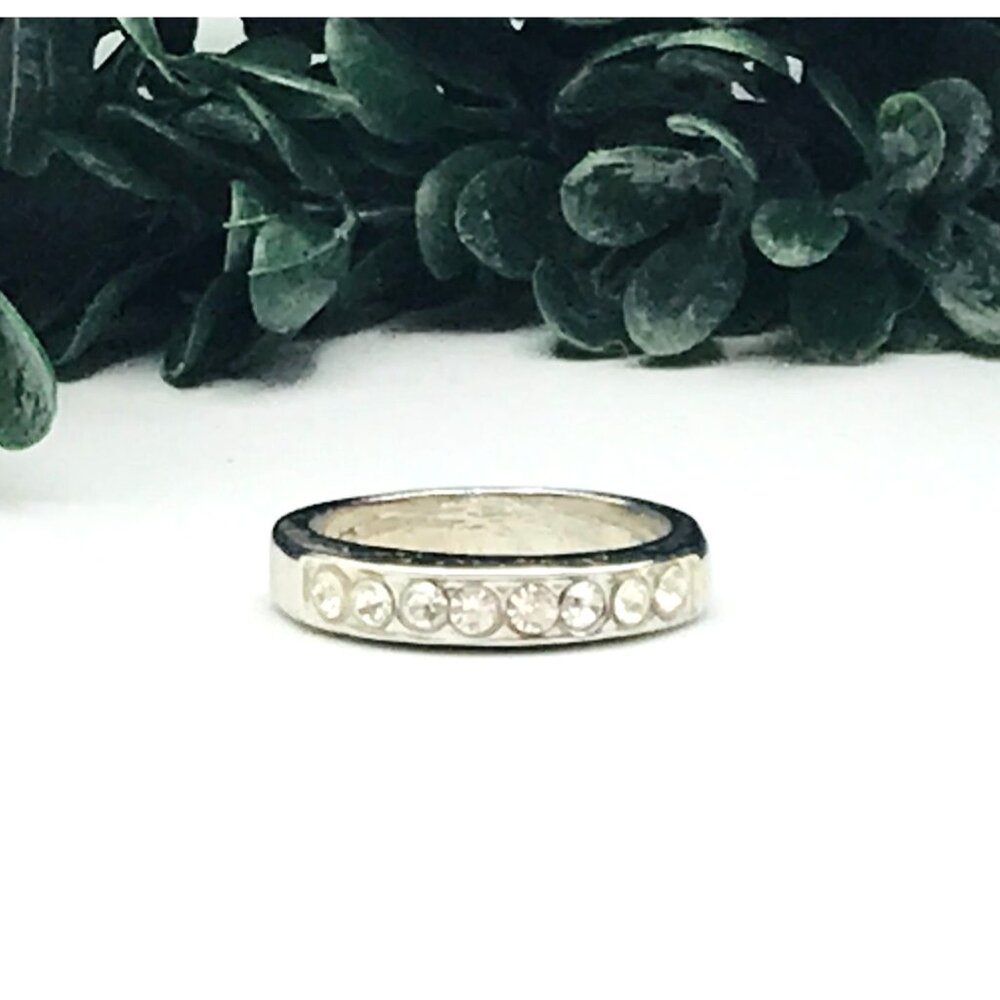 Silver tone ring, band style with clear rhinestones, size 8